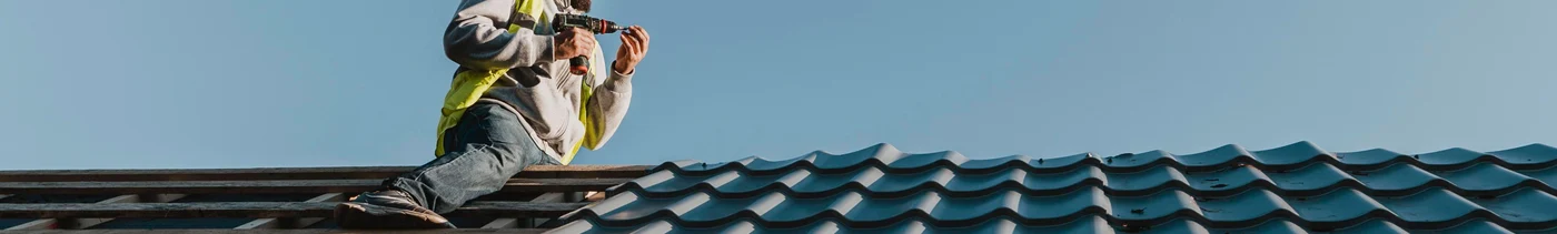 432c2915-f5ca-49d8-b7ad-8589869a1434-long-shot-man-working-roof.jpg
